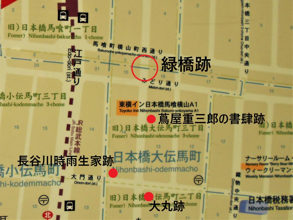 住所表示版に緑橋、大丸、蔦屋重三郎書肆、長谷川時雨生家のそれぞれの跡地を記した地図の画像。