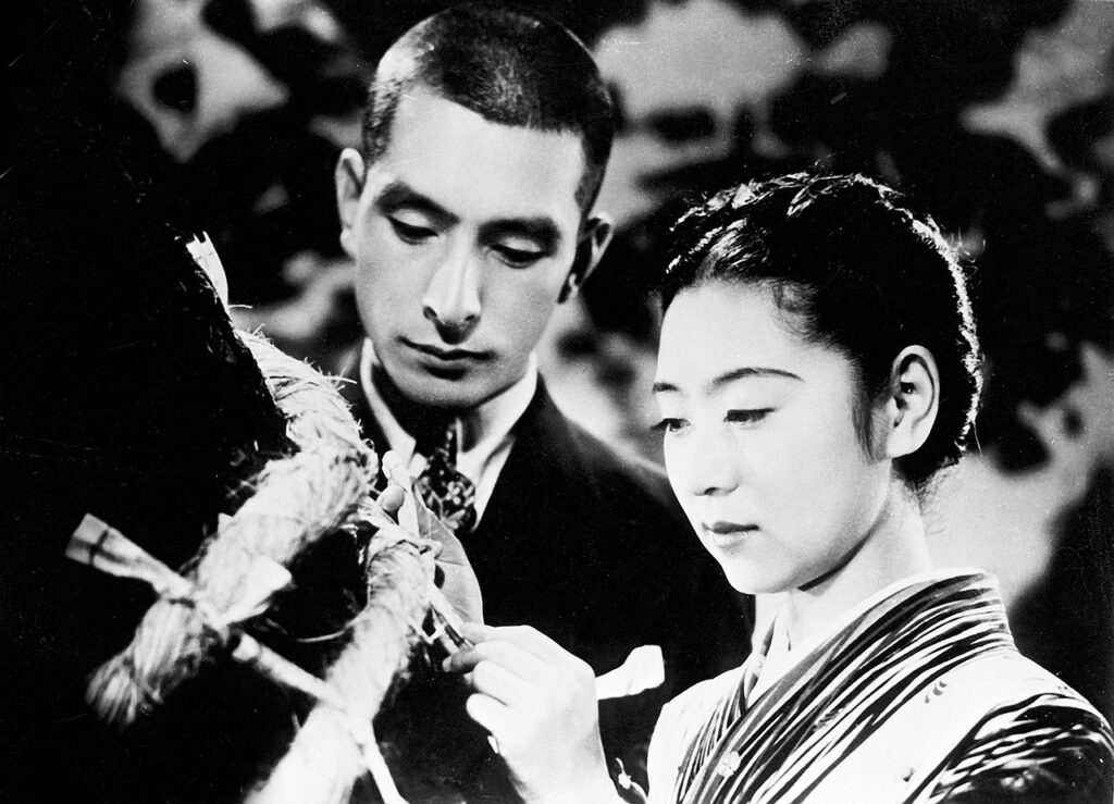 『愛染かつら』（1938）主演の田中絹代と上原謙（Wikipediaより20220611ダウンロード）の画像。